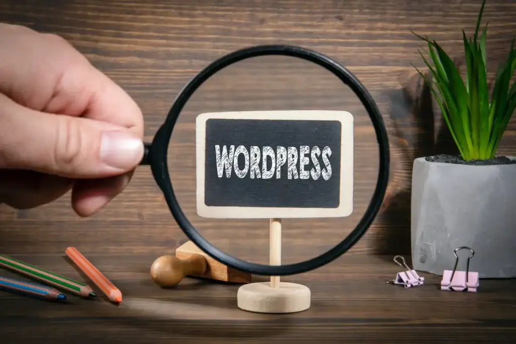 Magnifying glass highlighting the WordPress written on a blackboard.