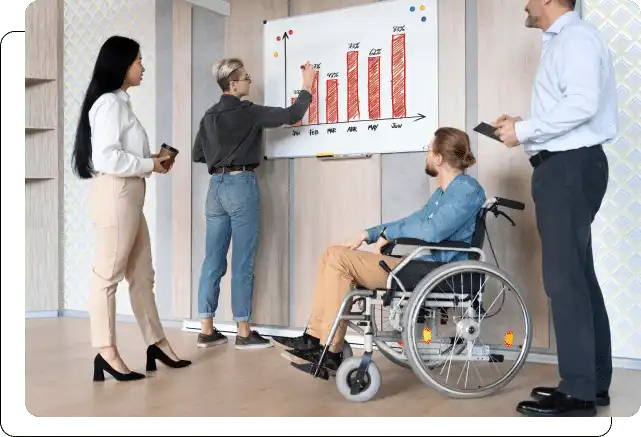 Four professionals analyzing a bar chart during a meeting, with one individual using a wheelchair.